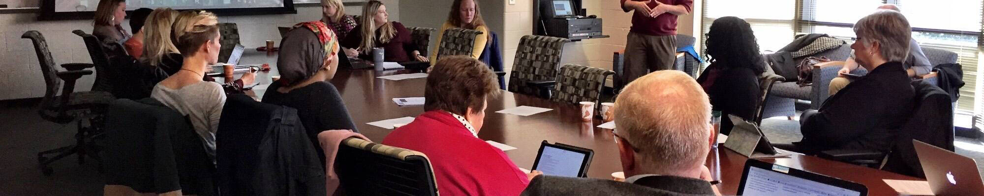 Faculty seated around a table